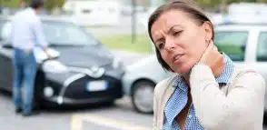 a woman holding her neck after an accident