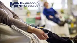 Patient undergoing chemotherapy, seated with blood bag for treatment in a medical setting