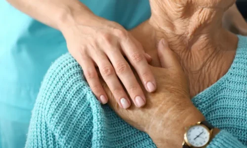 a-nurse-holding-a-womans-hand