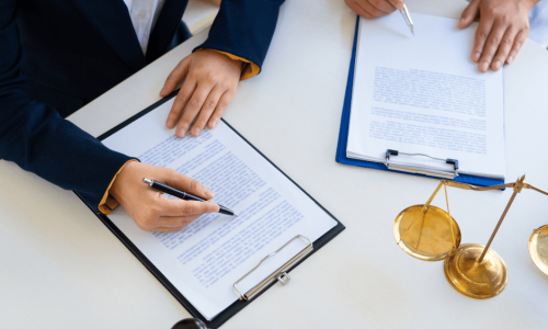 an attorney discussing legal documents with a client